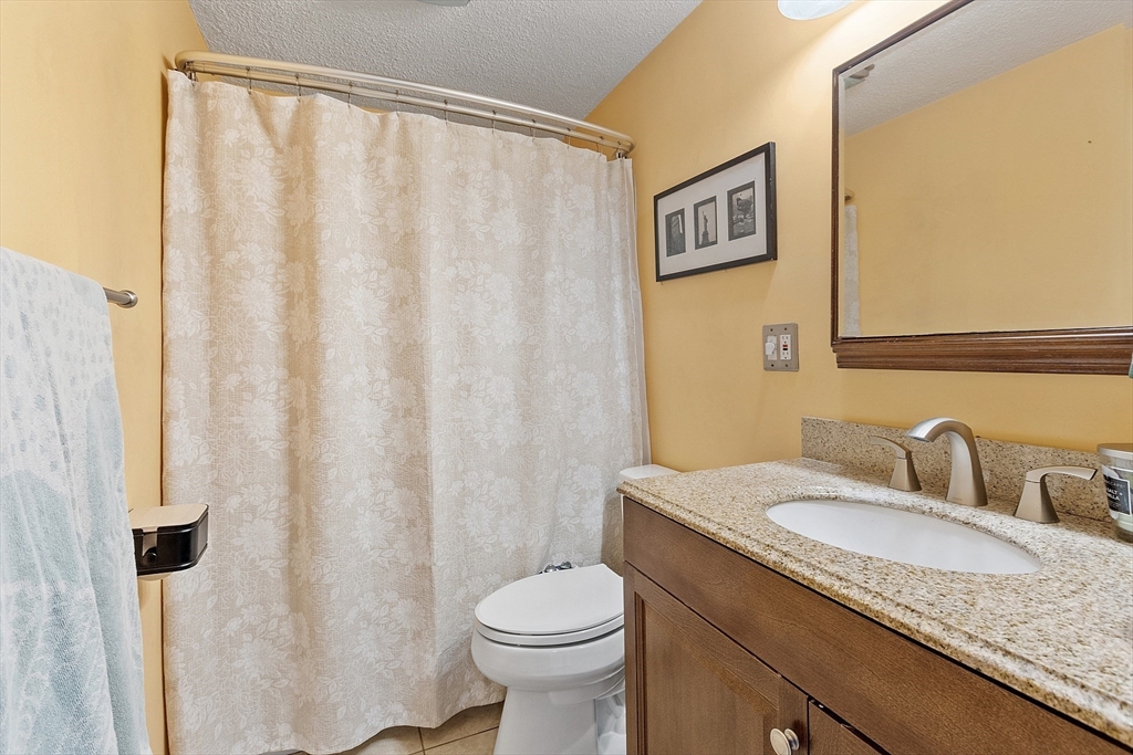 2 Edith Road Hudson, MA 01749 - Photo 10 of 23 a bathroom with a granite countertop sink and a mirror