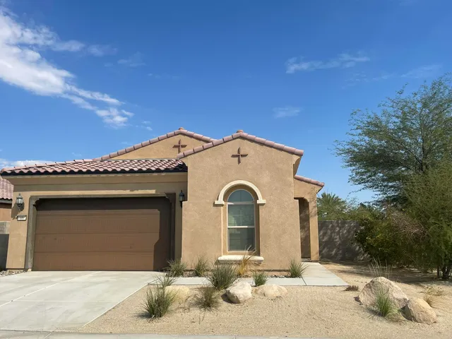 a view of a white house with a yard