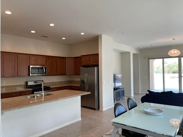 a kitchen with kitchen island a sink stainless steel appliances and window