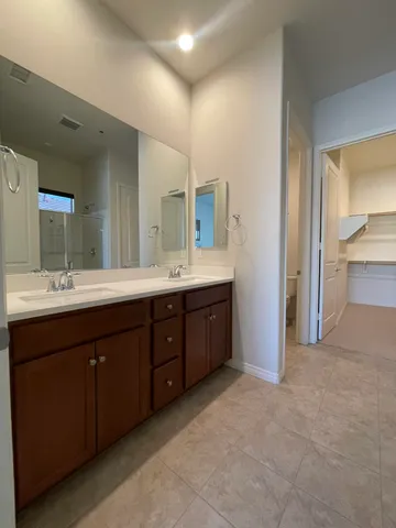 a spacious bathroom with a double vanity sink double and mirror