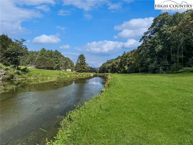 a view of a lake with a yard