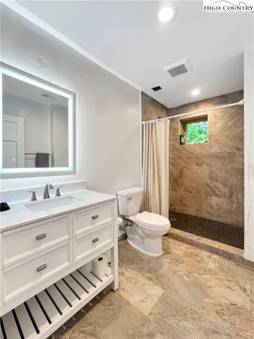 a bedroom with furniture and a window