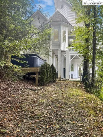 a view of a porch with furniture and garden