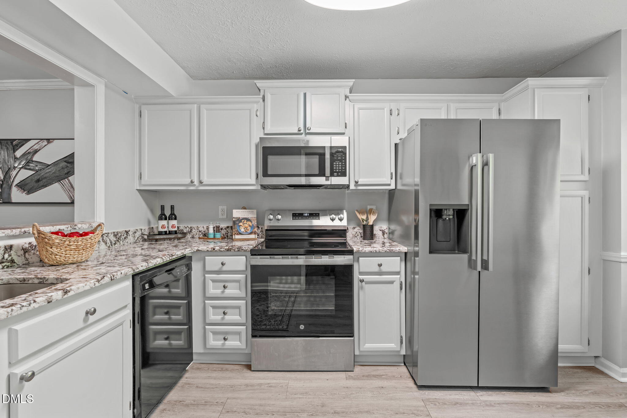 203 Oak Hollow Court Raleigh, NC 27613 - Photo 6 of 37 a kitchen with stainless steel appliances granite countertop a stove and a refrigerator