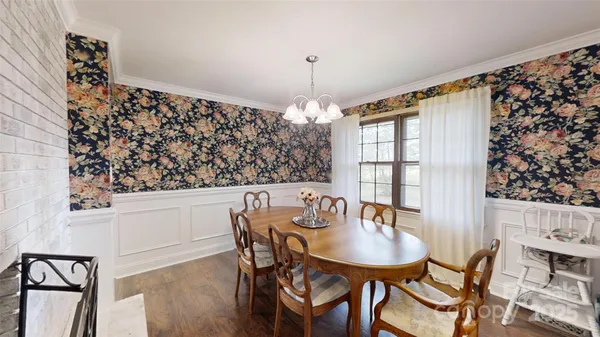 a view of a dining room with furniture and chandelier