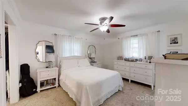 a view of walk in closet with clothes