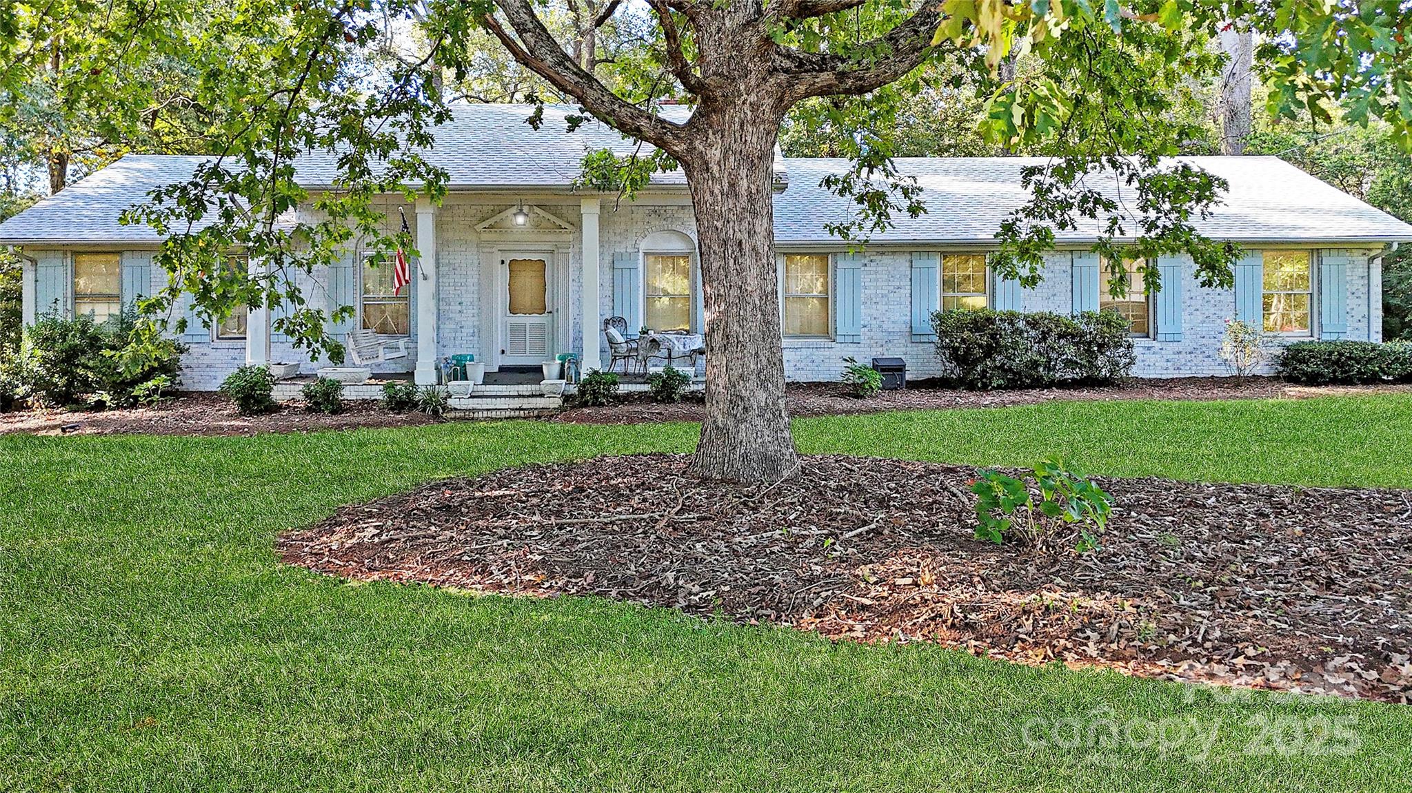 5298 Hoover Elmore Road Vale, NC 28168 - Photo 29 of 29 a front view of a house with a garden and trees