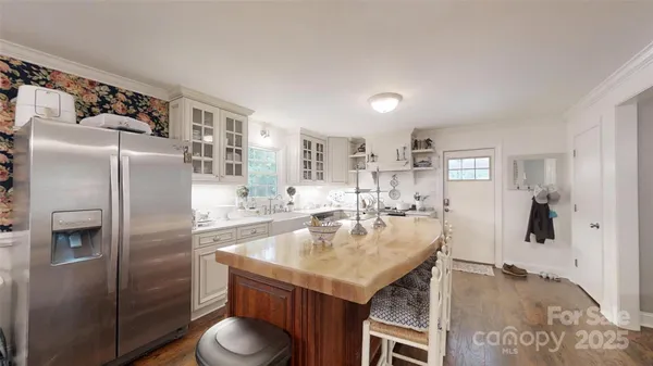 a bathroom with a granite countertop sink a shower a mirror and vanity