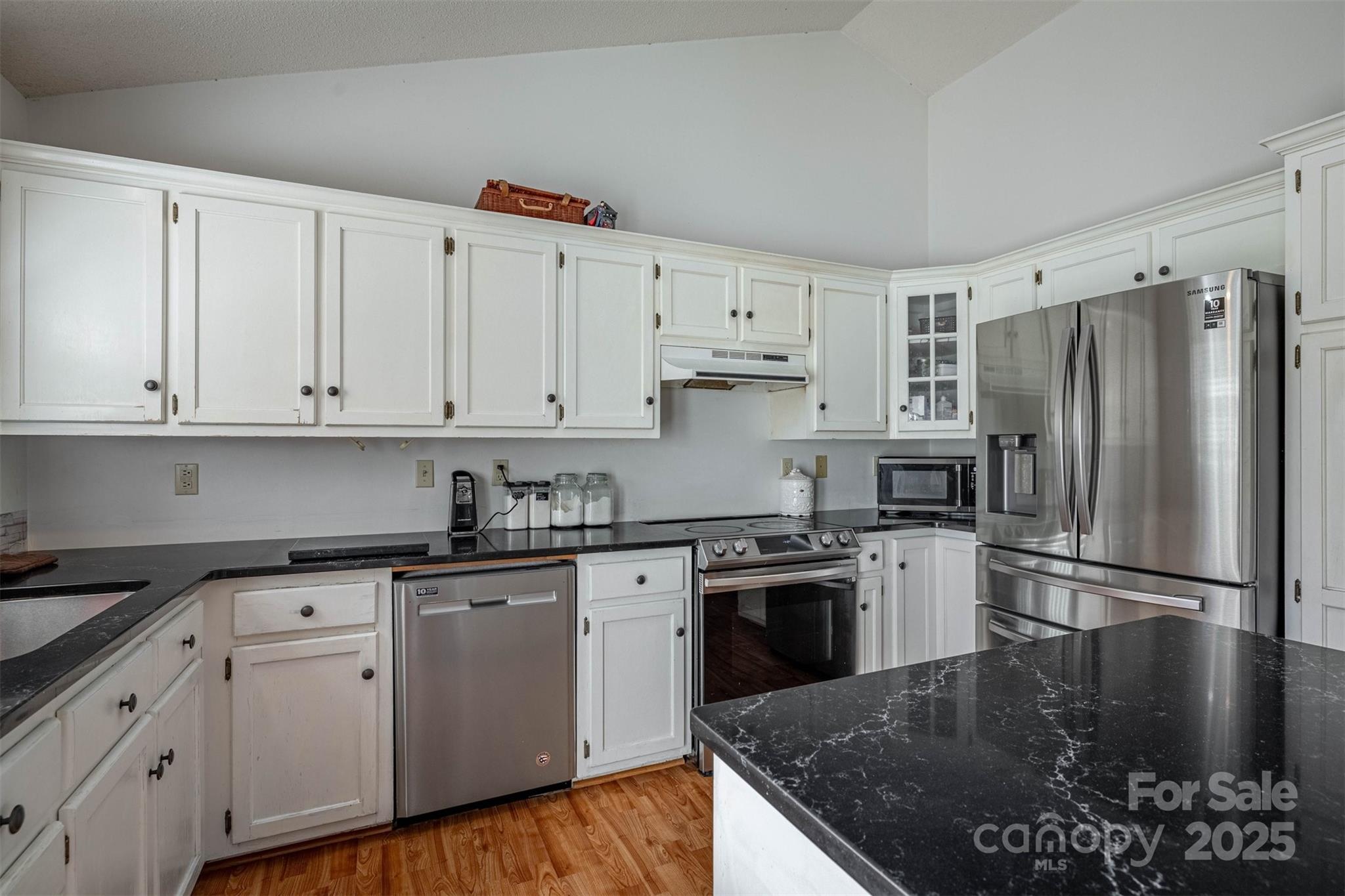 2693 Farmland Acrs Road Morganton, NC 28655 - Photo 20 of 33 a kitchen with stainless steel appliances granite countertop a stove a sink dishwasher a refrigerator and white cabinets