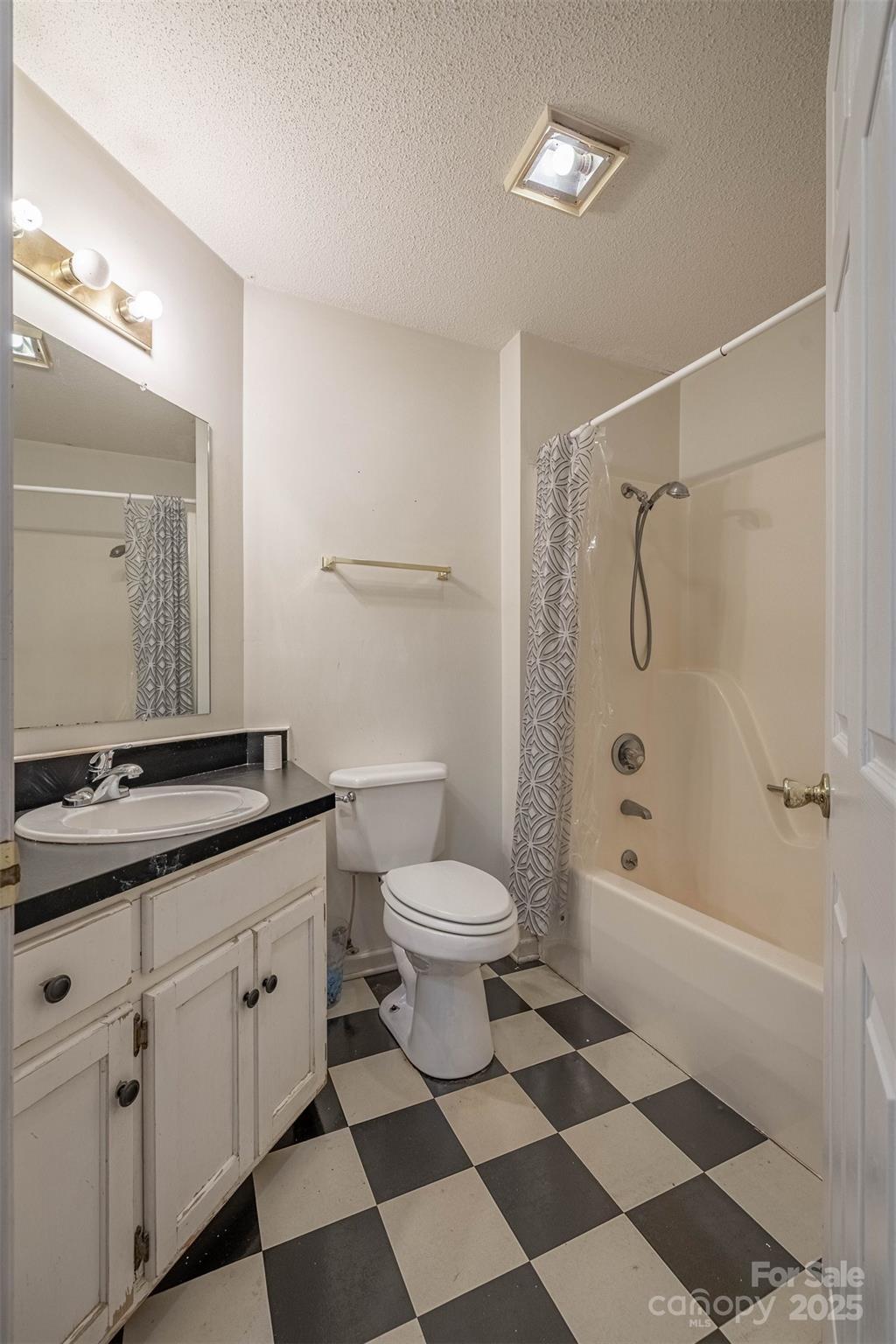 2693 Farmland Acrs Road Morganton, NC 28655 - Photo 28 of 33 a bathroom with a granite countertop sink toilet a mirror a vanity and shower