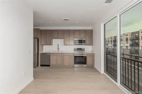 a kitchen with stainless steel appliances a refrigerator sink and cabinets