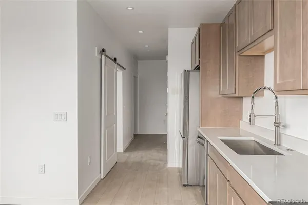 a kitchen with a sink and a refrigerator