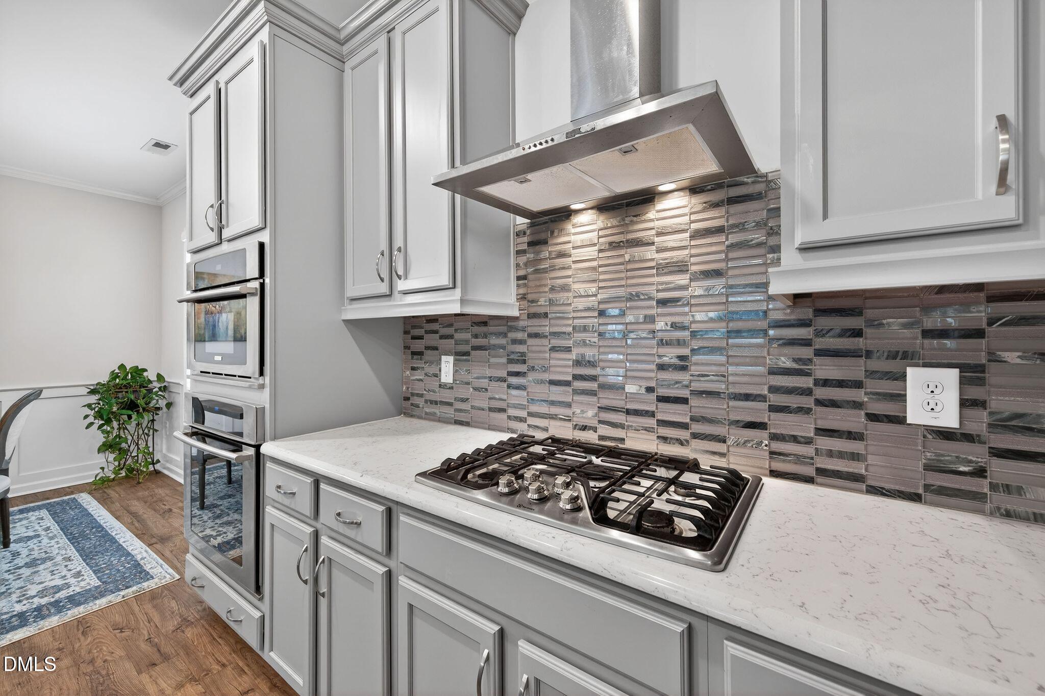 528 Spring Flower Court Cary, NC 27511 - Photo 19 of 51 a kitchen with granite countertop a stove sink and cabinets