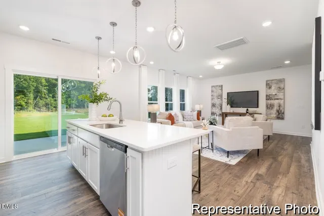 a large kitchen with stainless steel appliances kitchen island a large island in the center