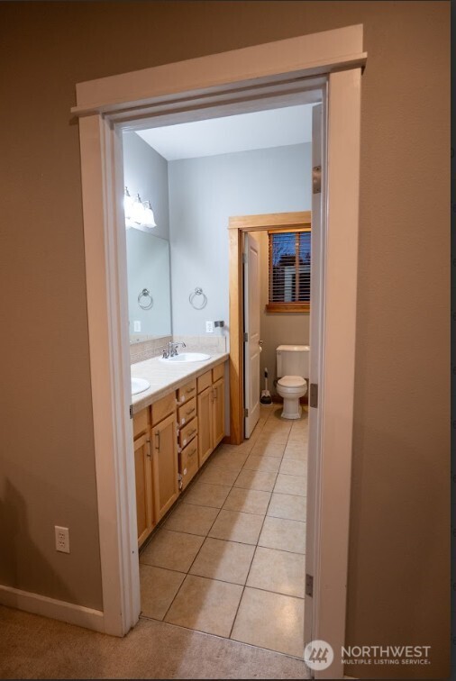 9723 Phillips Road Southeast Port Orchard, WA 98367 - Photo 18 of 37 a bathroom with a sink a toilet and mirror