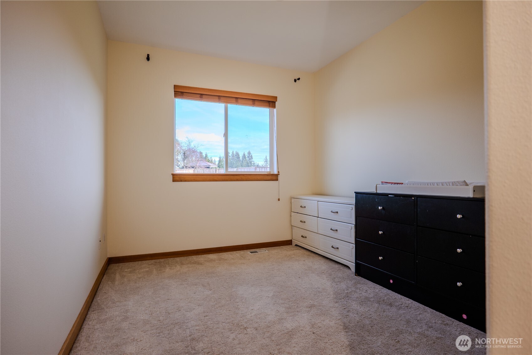 9723 Phillips Road Southeast Port Orchard, WA 98367 - Photo 22 of 37 an empty room with a dresser and window