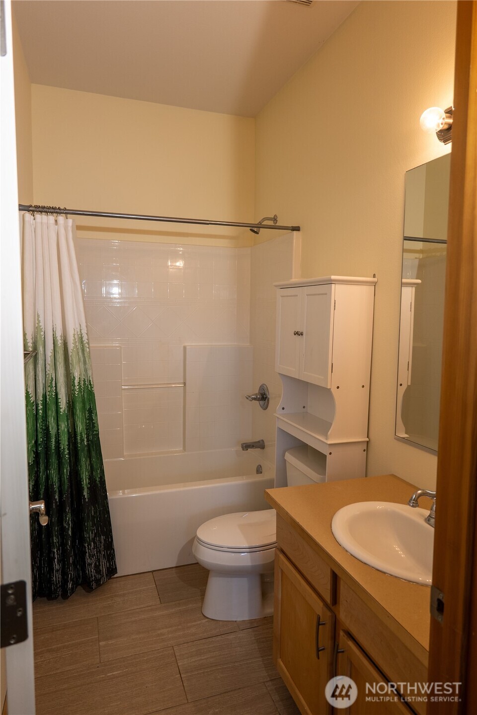 9723 Phillips Road Southeast Port Orchard, WA 98367 - Photo 29 of 37 a bathroom with a sink a toilet a mirror and shower