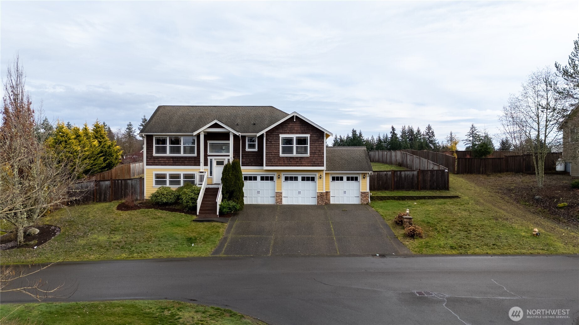 9723 Phillips Road Southeast Port Orchard, WA 98367 - Photo 36 of 37 a front view of a house with a yard and garage