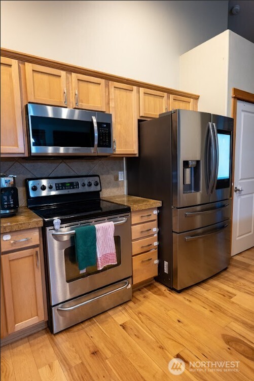 9723 Phillips Road Southeast Port Orchard, WA 98367 - Photo 10 of 37 a kitchen with stainless steel appliances granite countertop a refrigerator stove and microwave