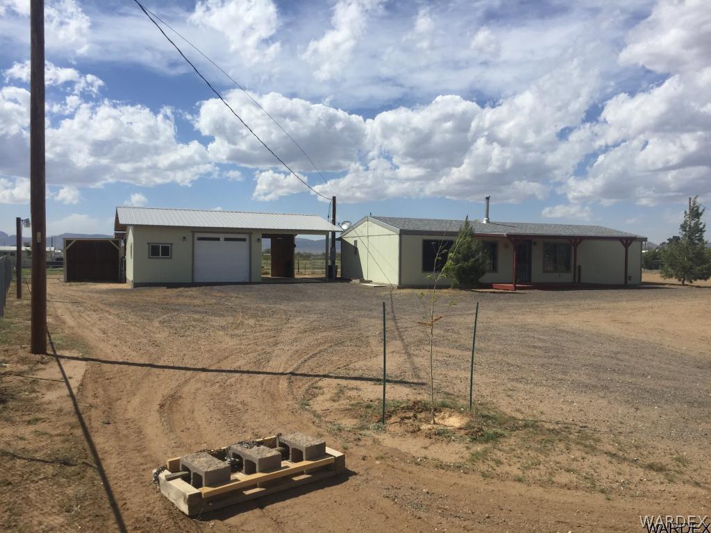 3589 Mobile Road Golden Valley, AZ 86413 - Photo 1 of 11 a front view of a house with parking space