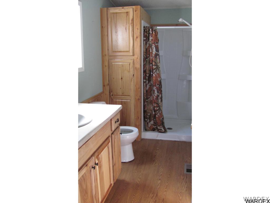 3589 Mobile Road Golden Valley, AZ 86413 - Photo 8 of 11 a bathroom with a sink a toilet and shower