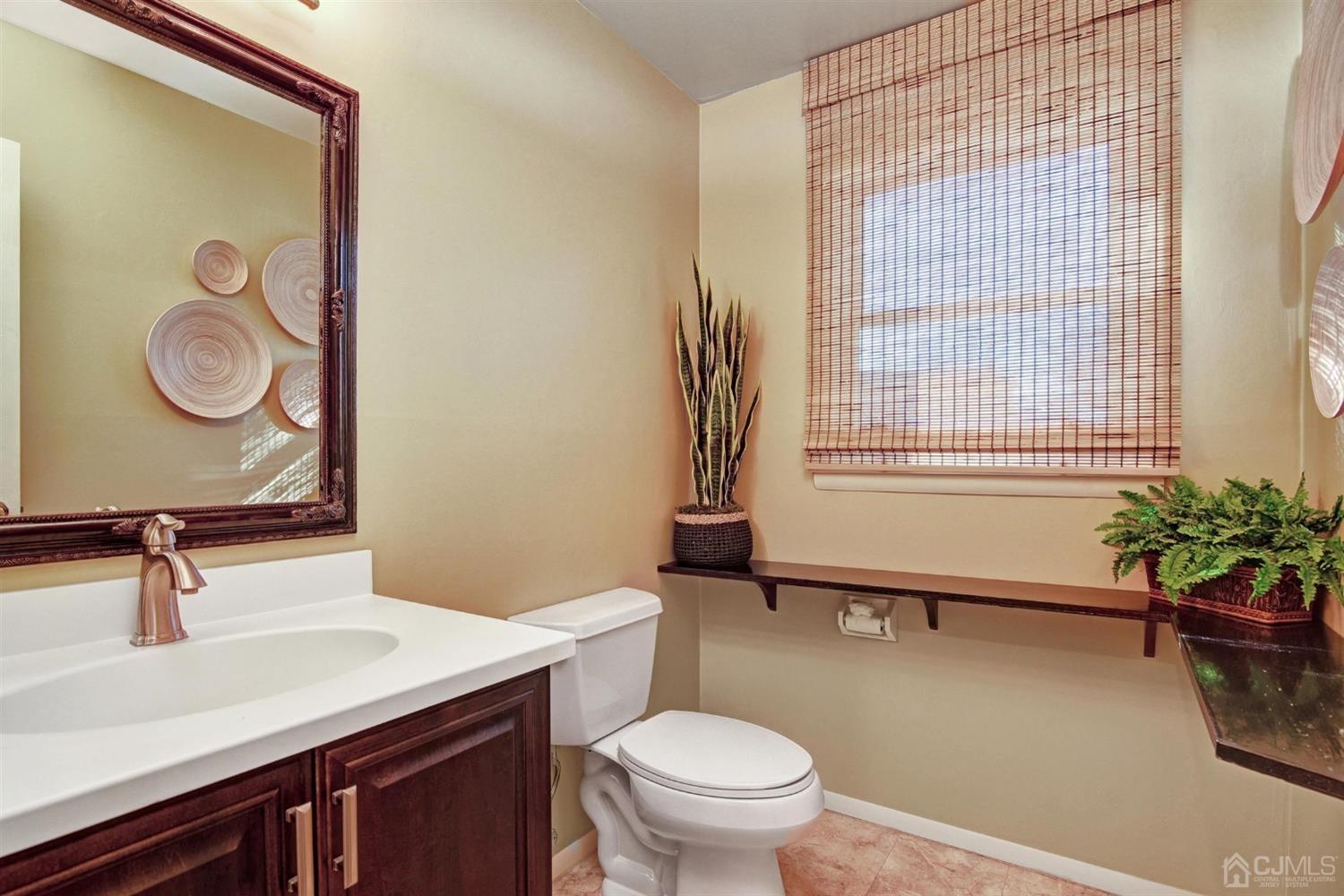 12 Warwick Road Edison, NJ 08820 - Photo 8 of 40 a bathroom with a sink a toilet and a mirror