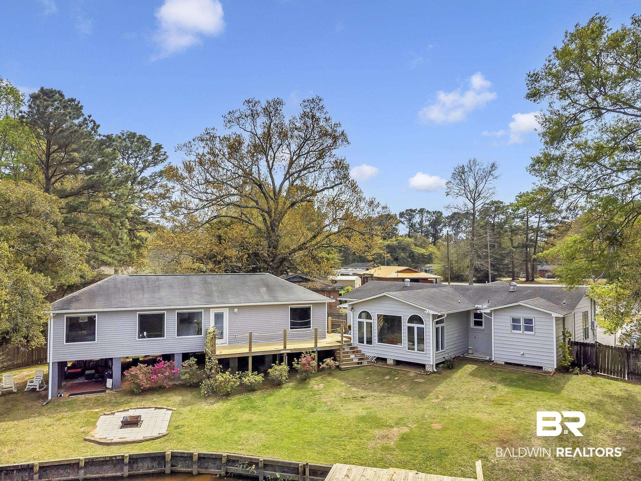 2901 Alston Court Mobile, AL 36605 - Photo 55 of 59 Back of house featuring fence, a fire pit, a deck, and a lawn