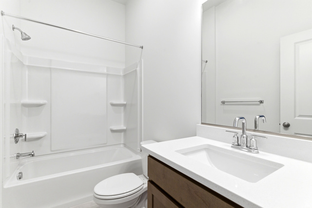 7243 West Terraine Road West Jordan, UT 84081 - Photo 21 of 31 Full bathroom featuring a white tub/shower combination, chrome fixtures, a wood-finish vanity with an integrated sink, and a large wall-mounted mirror