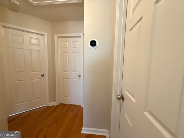 an empty room with closet and windows