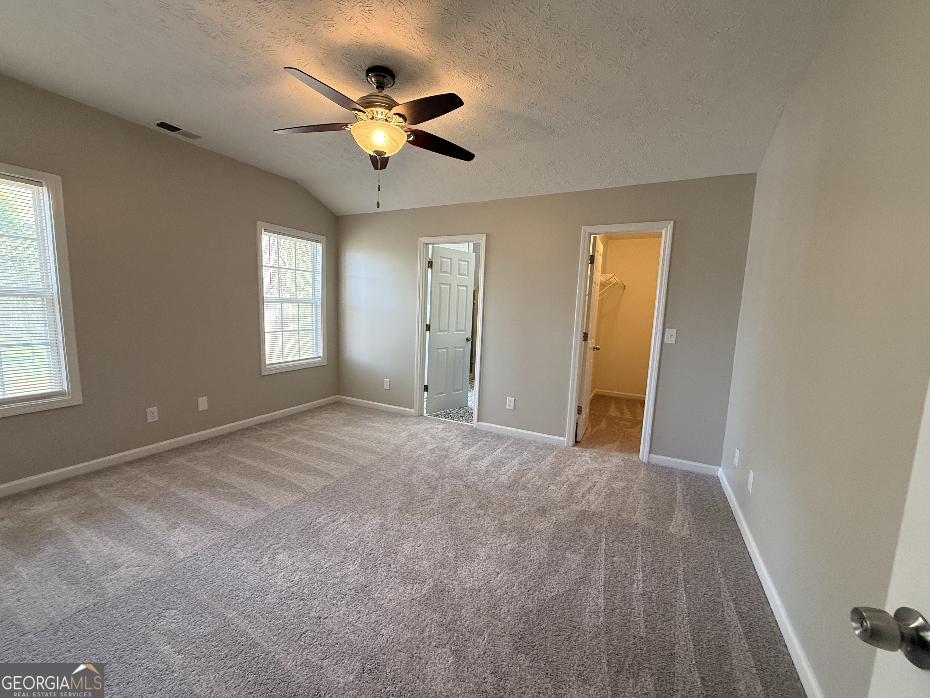 577 Pendergrass Road Winder, GA 30680 - Photo 12 of 25 an empty room with closet and windows