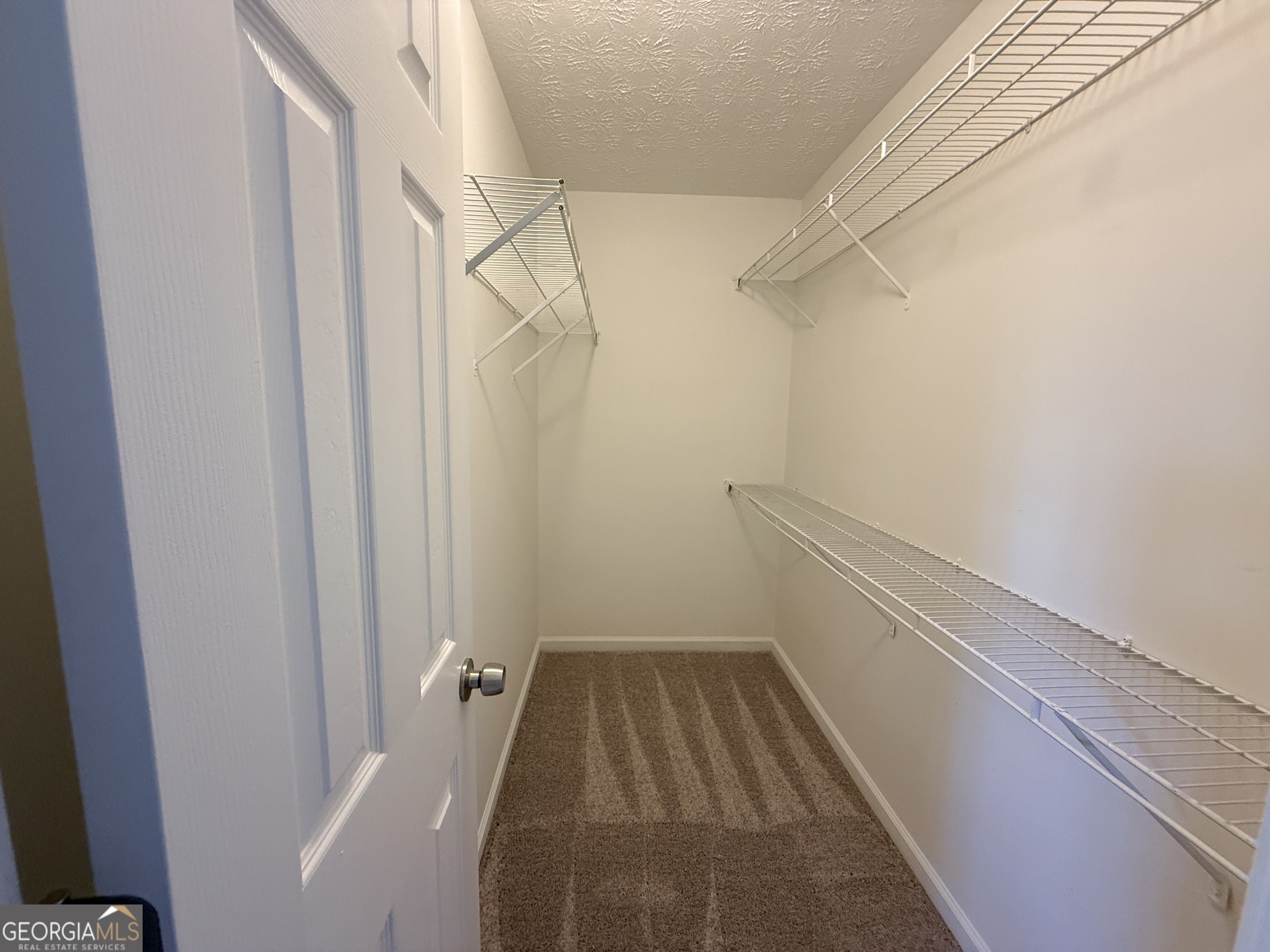 577 Pendergrass Road Winder, GA 30680 - Photo 13 of 25 a view of a room with racks on the wall