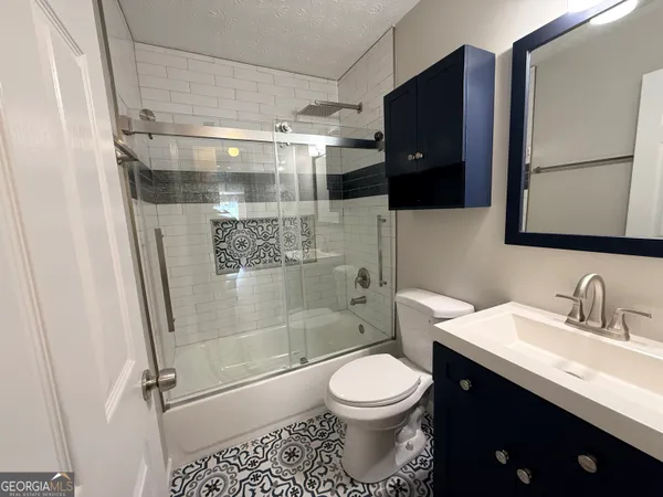a bathroom with a glass door shower