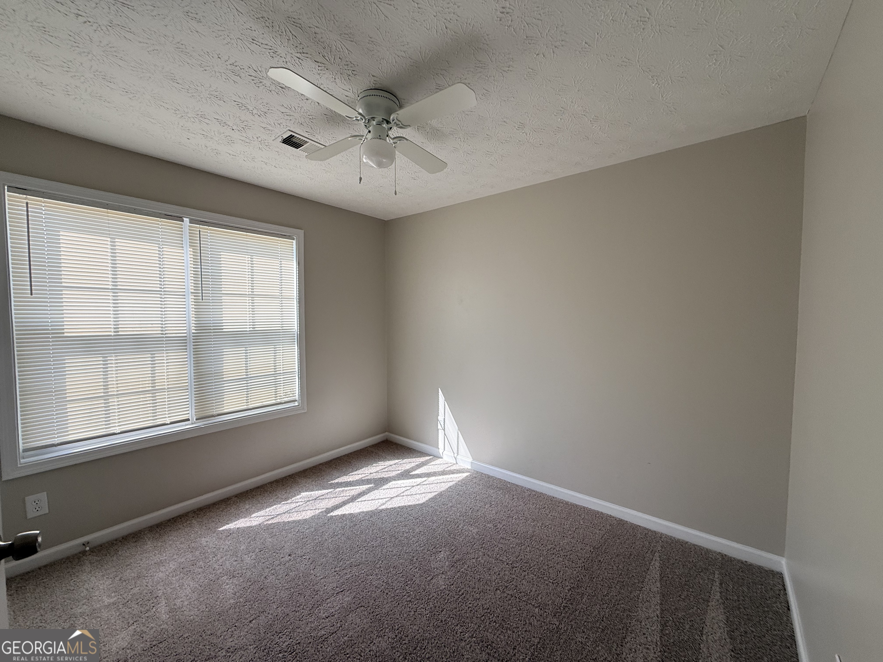 577 Pendergrass Road Winder, GA 30680 - Photo 18 of 25 an empty room with a window