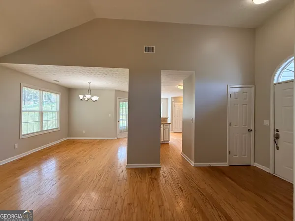 a view of a livingroom with a ceiling fan and window