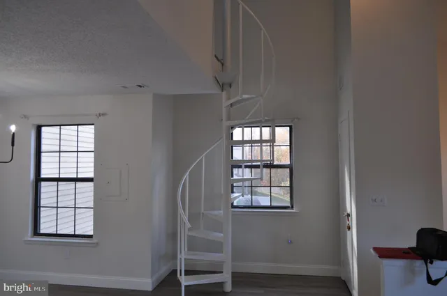 an empty room with windows and closet