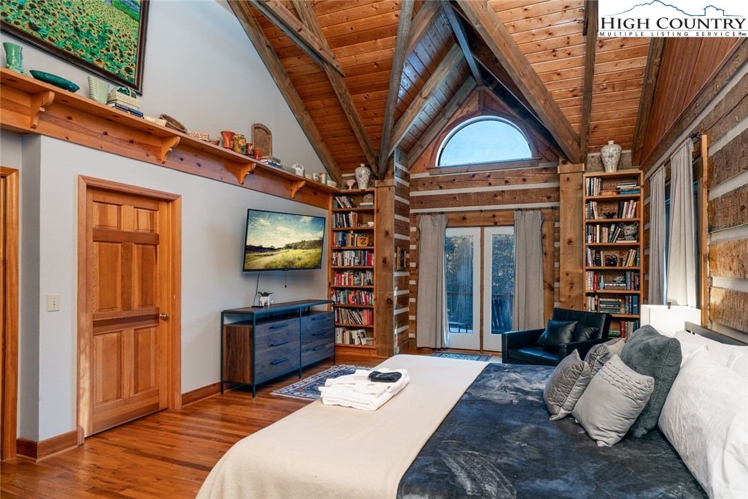 2560 Watauga River Road Sugar Grove, NC 28679 - Photo 18 of 50 a bedroom with a bed dresser and a large window
