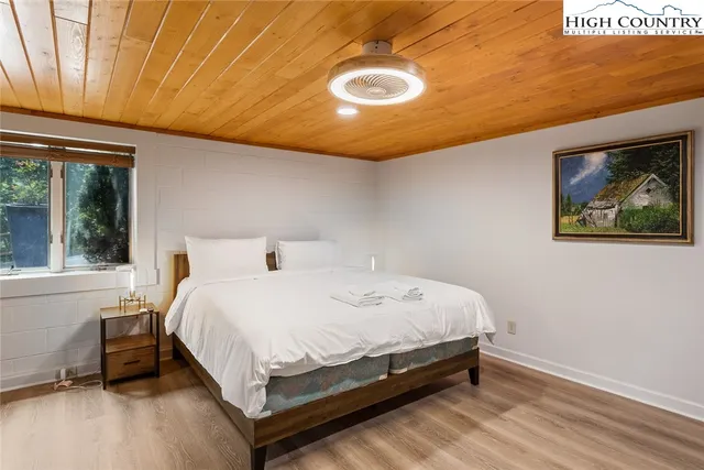 a bed sitting in a bedroom next to a window