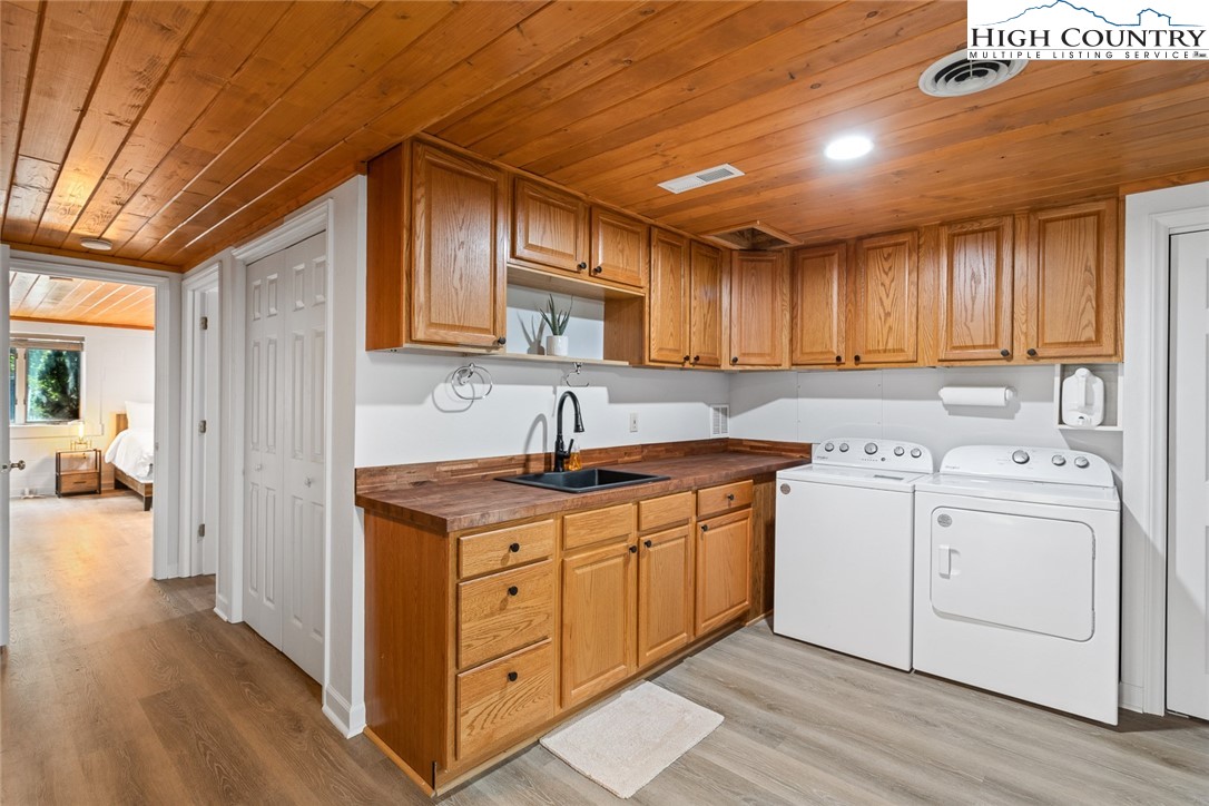 2560 Watauga River Road Sugar Grove, NC 28679 - Photo 29 of 50 a kitchen with a stove top oven sink and cabinets
