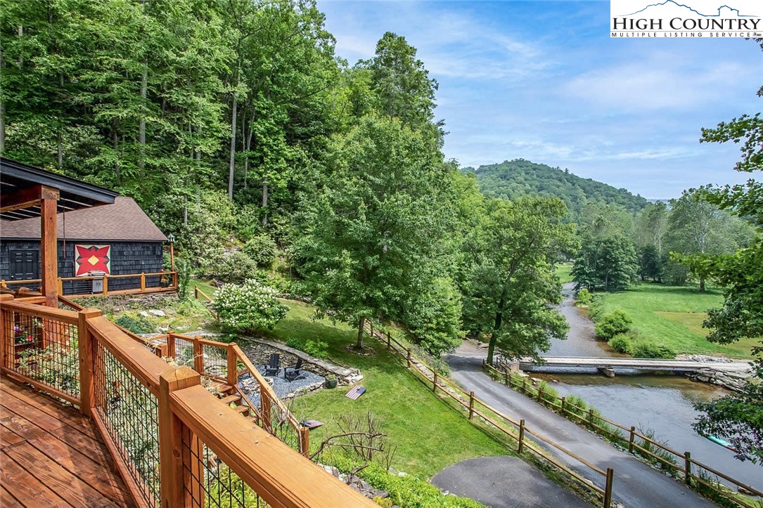 2560 Watauga River Road Sugar Grove, NC 28679 - Photo 41 of 50 a view of a wooden deck and a yard