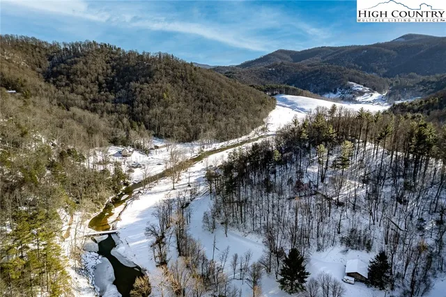 a view of a backyard with table and chairs and wooden fence