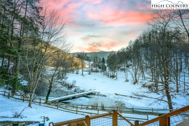a view of a yard with wooden fence