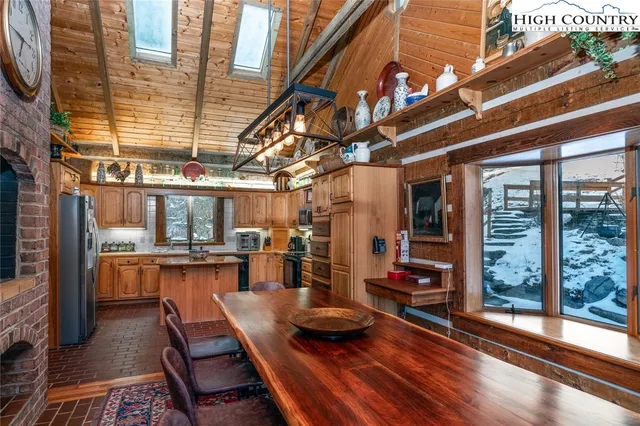 a view of a patio with dining table and chairs