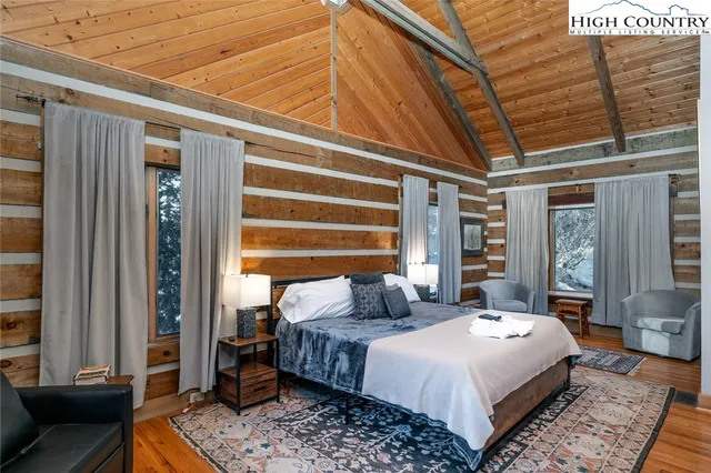 a bedroom with a bed a couch and dresser