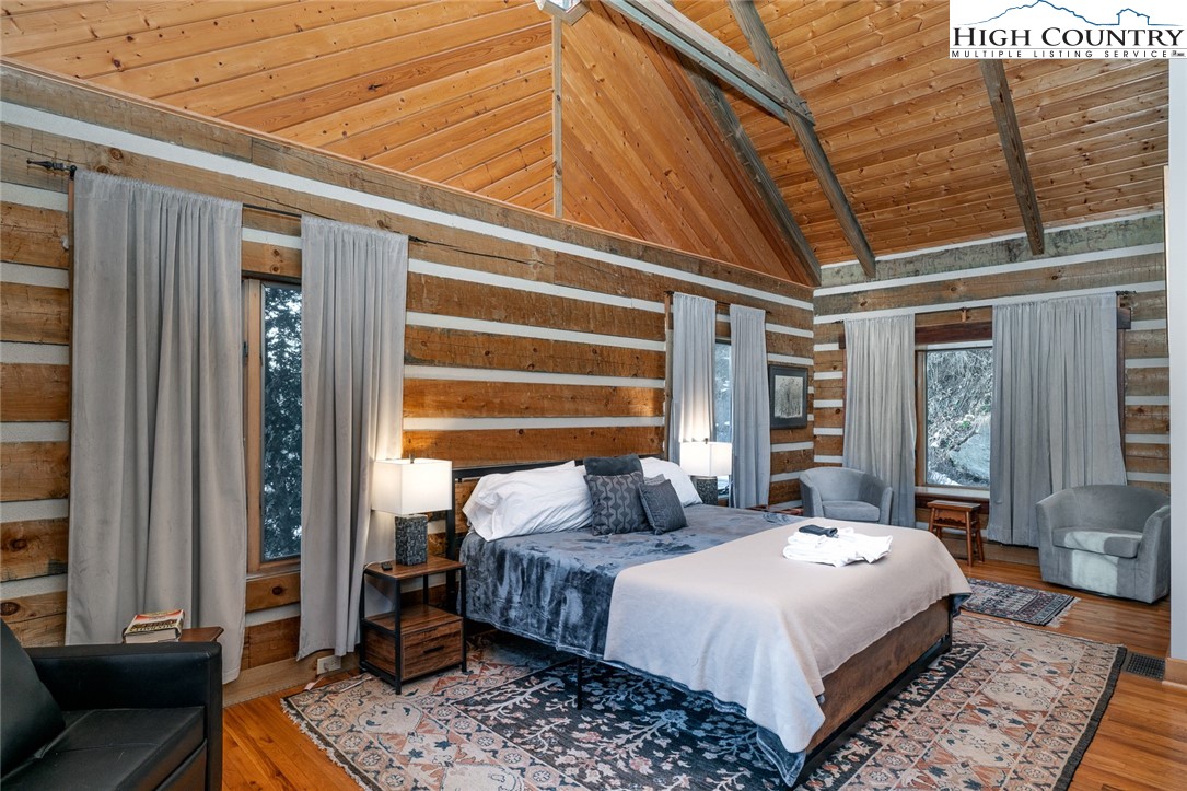 2560 Watauga River Road Sugar Grove, NC 28679 - Photo 6 of 50 a bedroom with a bed a couch and dresser