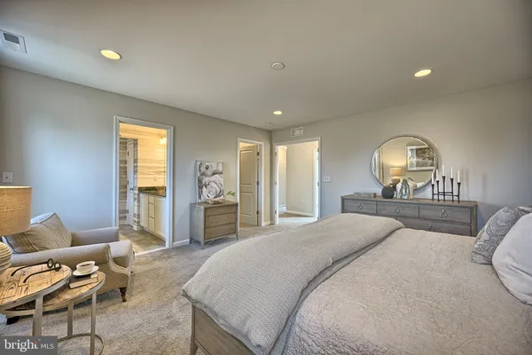 a spacious bedroom with a bed and glass window