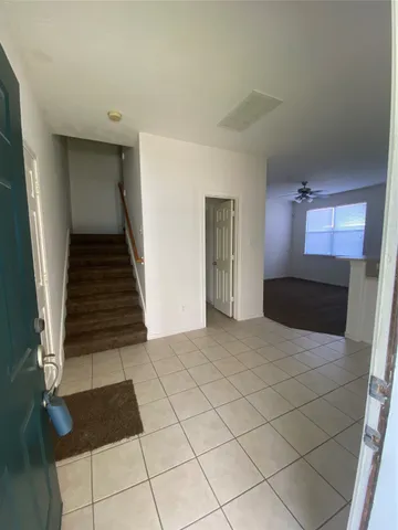 a kitchen with a refrigerator sink and cabinets