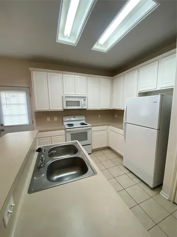 a view of a kitchen with a sink and a cabinets