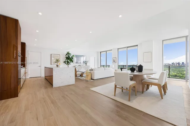 a living room with furniture and kitchen view