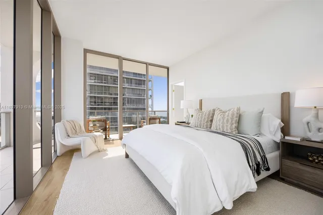 a spacious bedroom with a bed and a large window