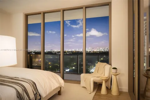 a bedroom with a bed and large window